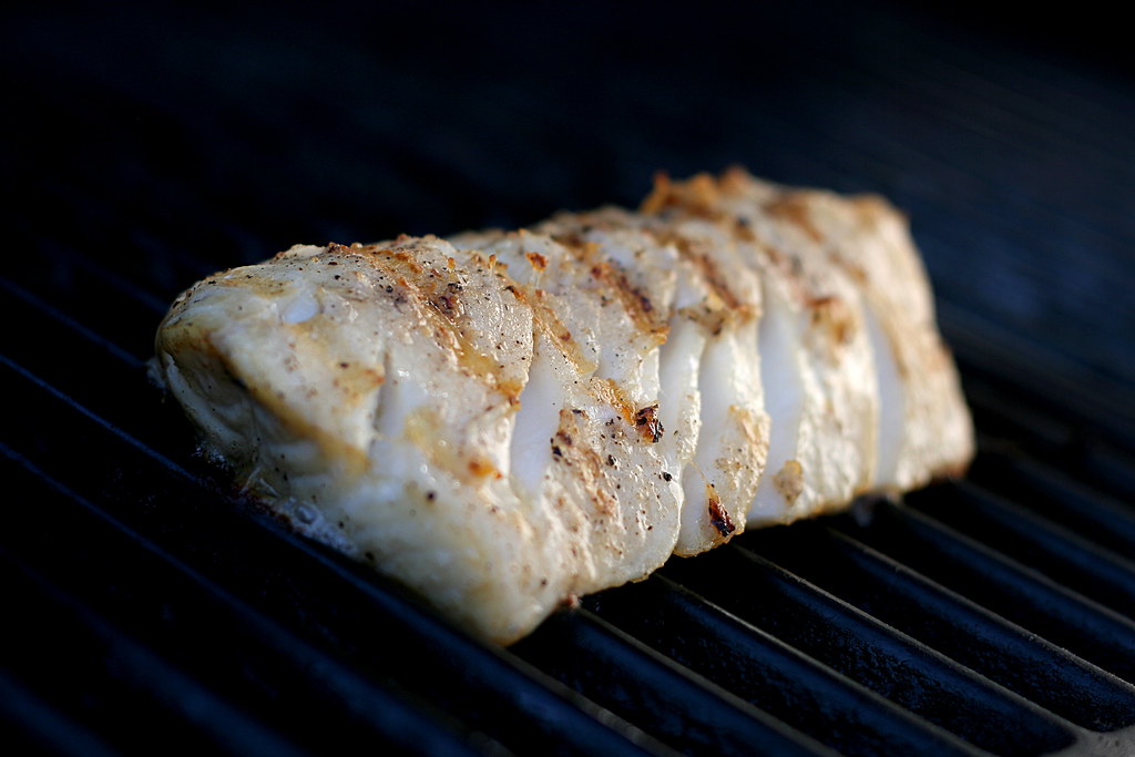 cod cooking on a grill