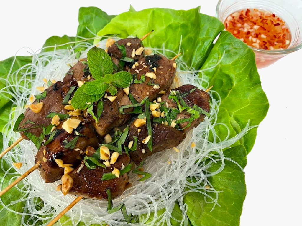 grilled pork with rice noodles over bed of lettuce