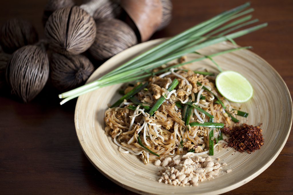 pad thai noodles with topping on a plate