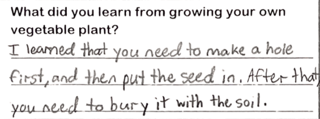 Student writing "I learned that you need to make a hole first, then put the seed in. After that, you need to bury it in the soil."