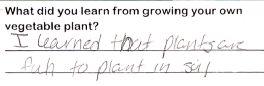 Student writing "I learned that plants are fun to plant in soil"