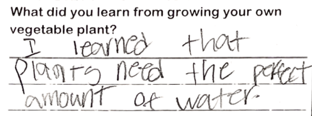 Student writing "I learned that plants need the perfect amount of water."