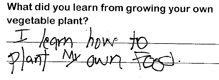 Student writing "I learn how to plant my own food."