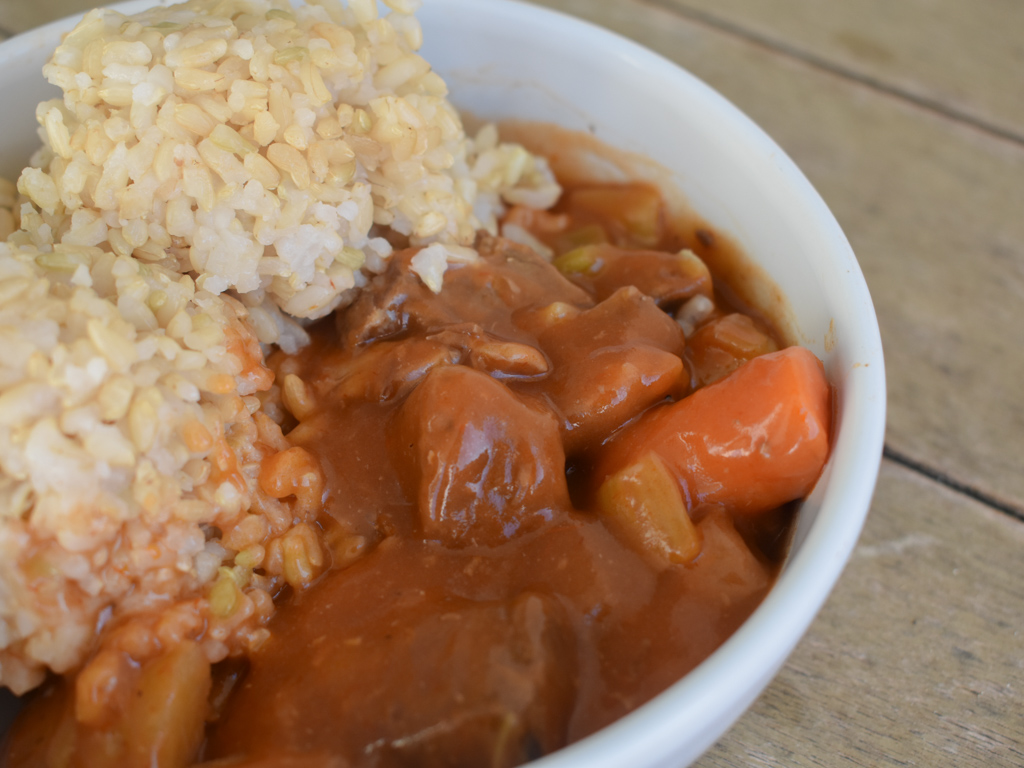 Beef stew with brown rice in a bowl