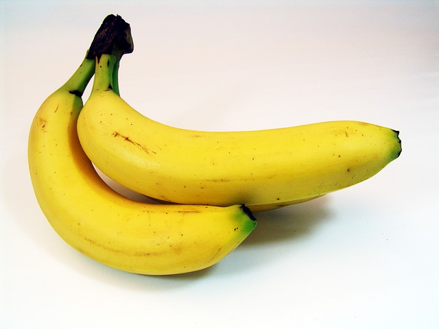 Three bananas on white surface