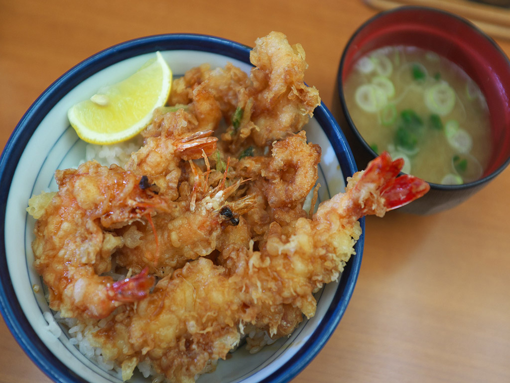 tendon, shrimp tempura over rice in bowl, with miso soup bowl on the side