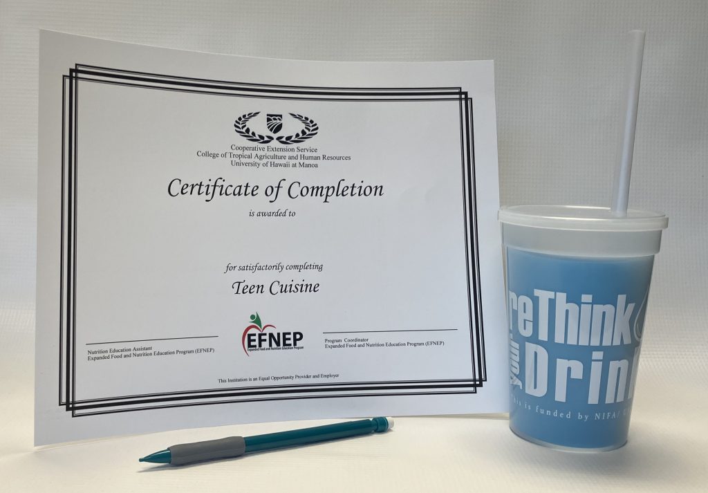 Certificate of Completion, a color-changing cup, and a mechanical pencil on a table.