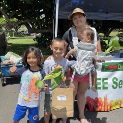 Family posing with bok choy seedling kit