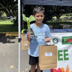 Participant posing with bok choy seedling kit