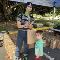 Family posing with bok choy seedling kit