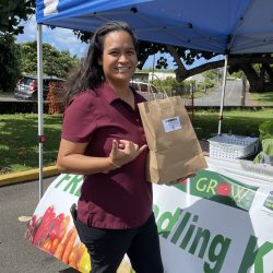 Participant posing with bok choy seedling kit