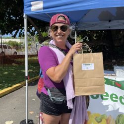 Participant posing with bok choy seedling kit