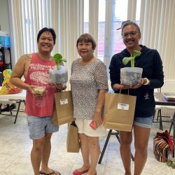 Participants pose with transplanted seedlings