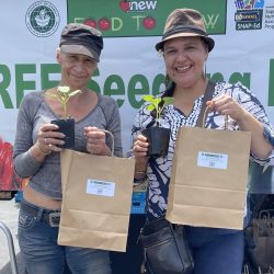 Participants pose with seedling kits