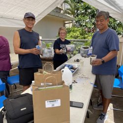 Participants pose with transplanted seedlings