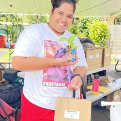 Participant posing with bok choy seedling kit