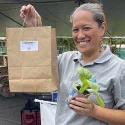 Participant posing with bok choy seedling kit