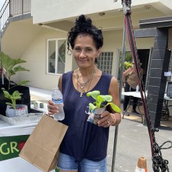 Participant posing with bok choy seedling kit