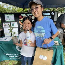 Participant posing with tomato seedling kit