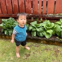 Keiki posing with bok choy planted from seeds.