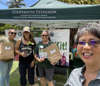 Molokai agency and UH staff at distribution tent